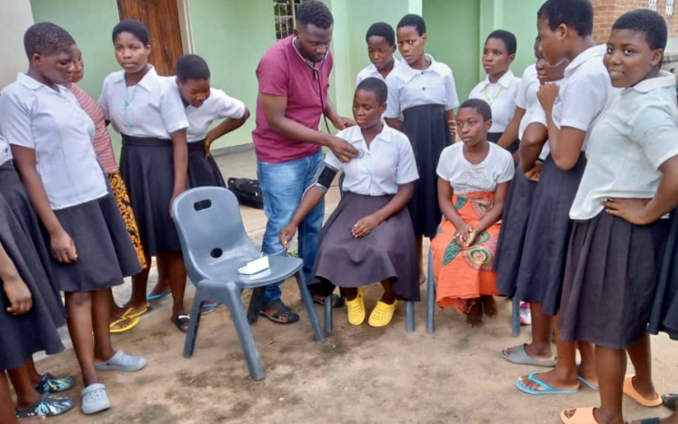 young woman has her blood pressure measured by a doctor