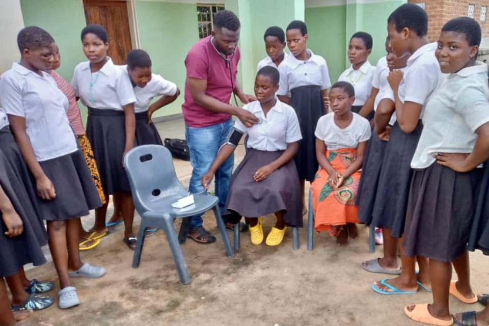 young woman has her blood pressure measured by a doctor